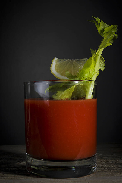 Bloody Mary cocktail with celery and lemon - Photo, Image