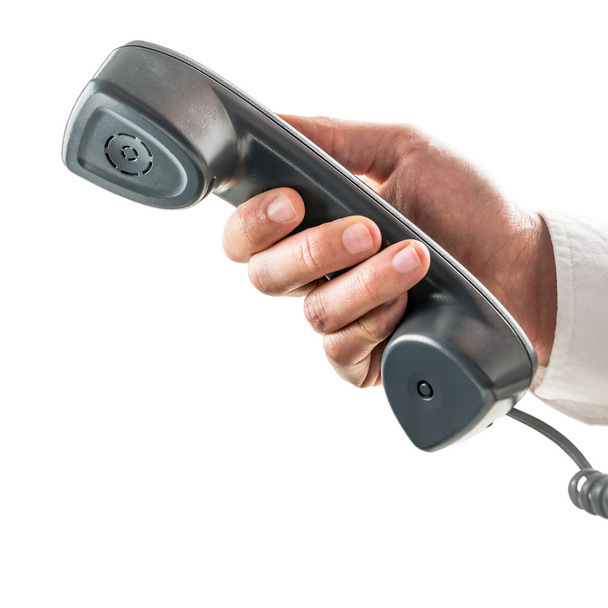 mannelijke hand met een telefoonhoorn - Foto, afbeelding