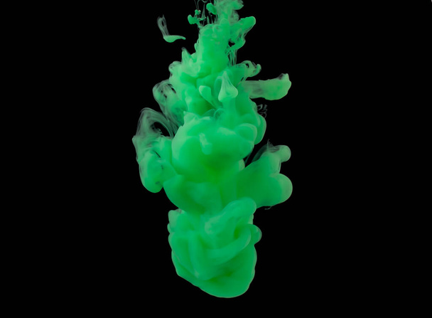 explosion of acrylic green paint in clear water. Black background - Photo, image