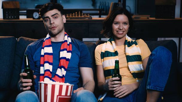 sport fans sitting with bottles of beer and watching championship  - Foto, Imagen