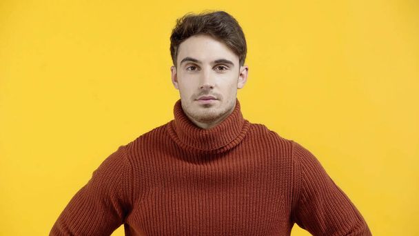 Brunette man in sweater looking at camera isolated on yellow  - Photo, Image