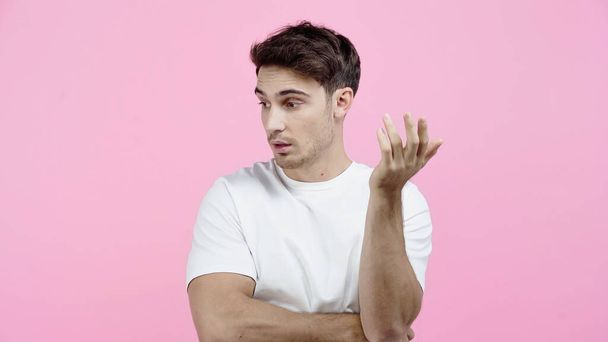 Upset man in white t-shirt looking away isolated on pink - Fotografie, Obrázek