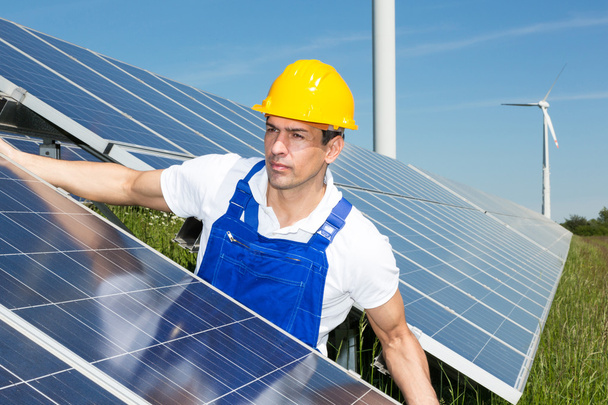 Photovoltaic engineer or installer installing solar panel - Foto, afbeelding