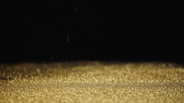 zamazany i błyszczący złoty pył na czarnym tle  - Zdjęcie, obraz