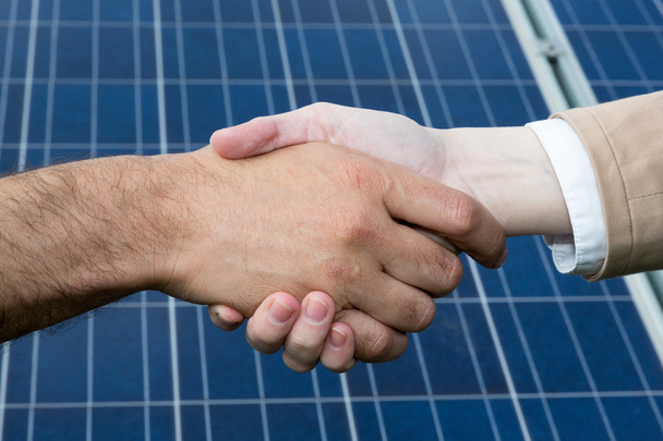 A handshake in front of solar energy panels - Fotografie, Obrázek