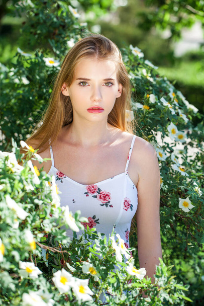 Close-up portrait of a teenage girl on the background of a summer park - Photo, Image