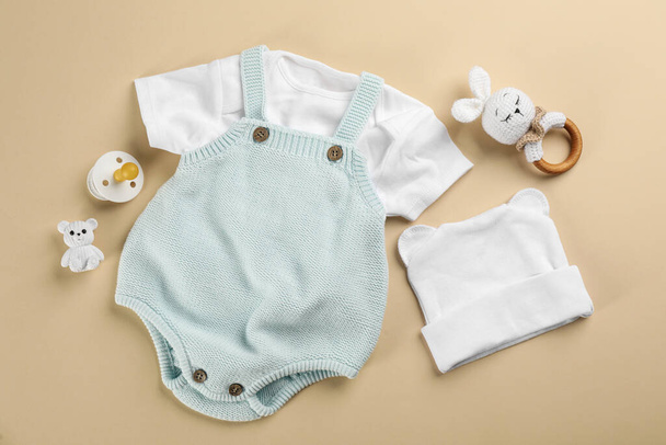 Flat lay composition with baby clothes and accessories beige background - Photo, Image