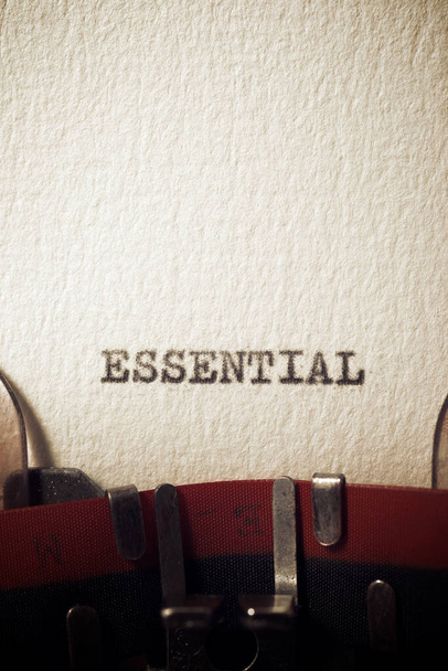 The word essential written with a typewriter. - Foto, Imagem