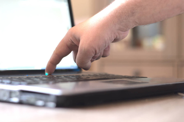 businessman's hand touching the keys of a laptop in the office - Photo, Image