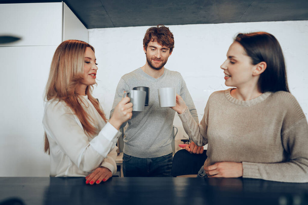 Young businesspeople colleagues having a coffee break in office, drinking and talking - 写真・画像