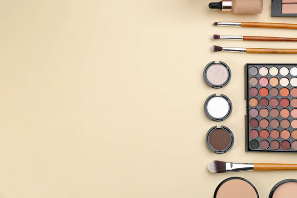 Flat lay composition with makeup brushes on beige background, space for text - Photo, Image