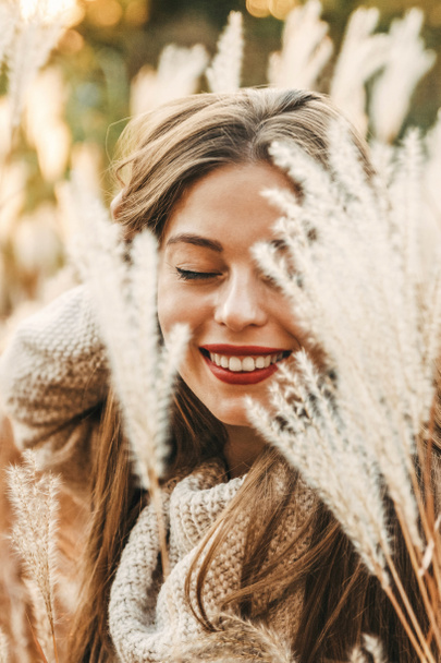 Portrait of a happy smiling female with her eyes closed at autum - Photo, Image