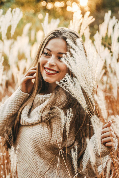 Portrait of a happy smiling female at autumn in the field. - Photo, Image