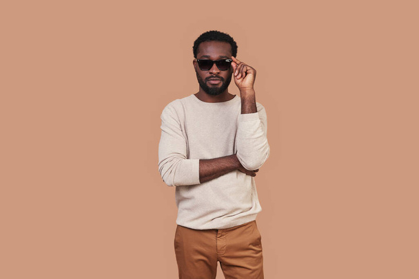 Handsome young African man in casual closing adjusting eyewear - Photo, Image