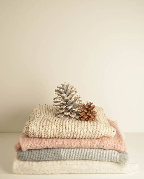 soft colored woolen fabric with fir cones close up - Valokuva, kuva
