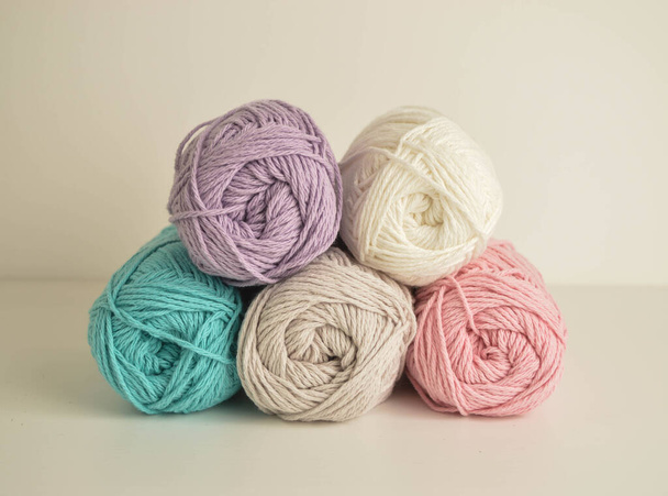 pastell coloured woolen balls for crocheting and handicraft - 写真・画像
