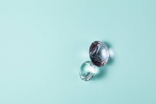 Precious gemstones for design gems jewellery. Big diamonds crystal on turquoise background. - Foto, afbeelding