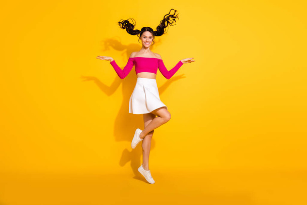 Full size photo of optimistic lovely brunette lady jump wear pink top skirt isolated on yellow background - Fotografie, Obrázek
