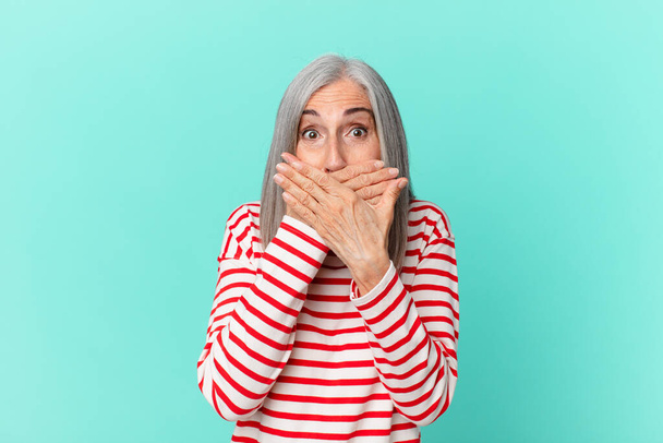 middle age white hair woman covering mouth with hands with a shocked - Foto, Imagem