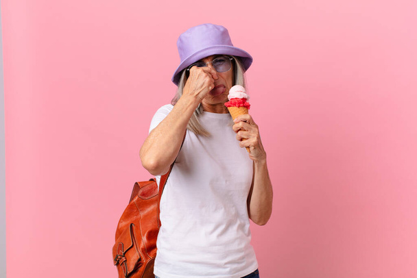 middle age white hair woman with an ice cream. summer concept - Photo, Image