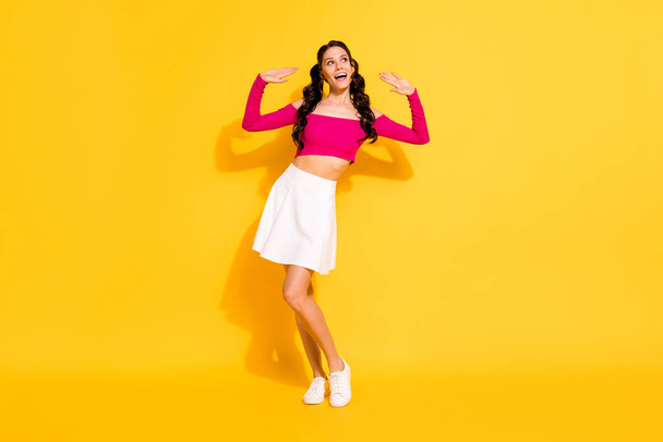 Full length body size view of attractive cheerful dreamy wavy-haired girl dancing having fun isolated over bright yellow color background - Фото, зображення