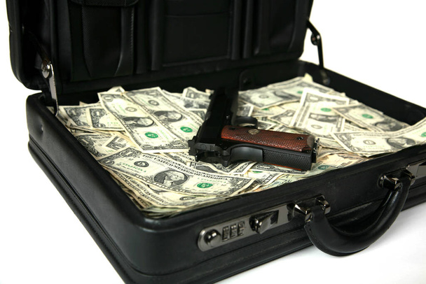 brief case full of cash.  isolated on white. hundred dollar bills. Money background. briefcase full of money. Lots of cash money. Close up American Money. 100 dollars. black briefcase stuffed with cash. brief case full of cash and a handgun.  - Foto, Bild