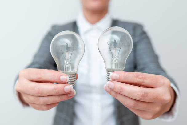 Lady Carrying Two Lightbulbs In Hands With Formal Outfit Presenting Another Ideas For Project, Business Woman Holding 2 Lamps Showing Late Technologies, Lighbulb Exhibiting Fresh Openion - Foto, immagini