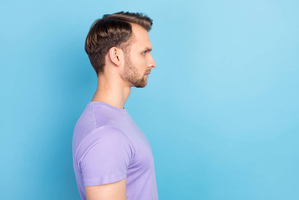 Profile portrait of young concentrated man look empty space wear purple isolated on blue color background - Valokuva, kuva