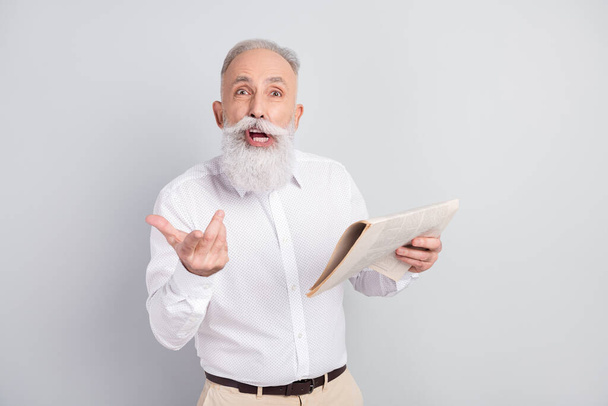 Photo of angry old man hold newspaper scream unhappy bad mood irritated news isolated on grey color background - Foto, immagini