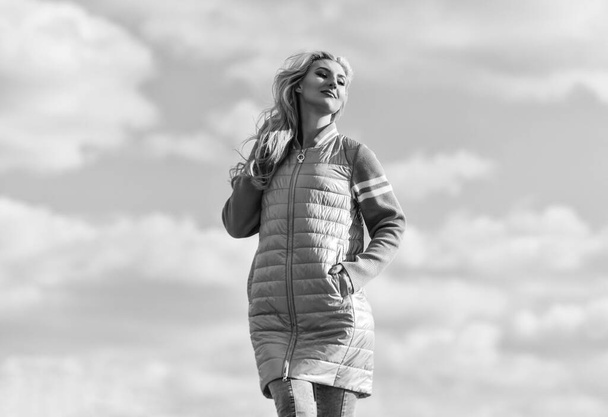 Windy day. Woman enjoying cool weather. Freshness of wind. Matching style and class with luxury and comfort. Beauty and fashion look. Girl jacket cloudy sky background. Woman fashion model outdoors - Foto, imagen