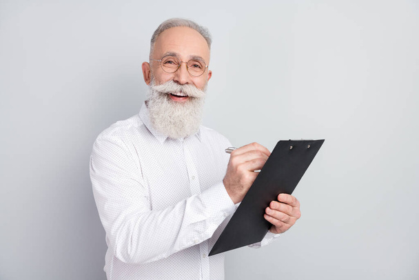 Photo of happy cheerful attractive old man write clipboard plan manager isolated on grey color background - Фото, зображення