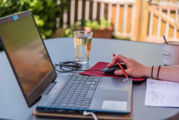 Office clerk works on laptop outdoors - workplace - Photo, Image