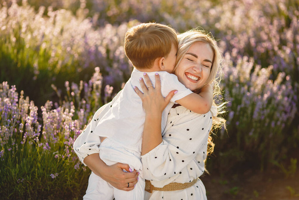 Little boy with her mother in a lavender field - Foto, imagen