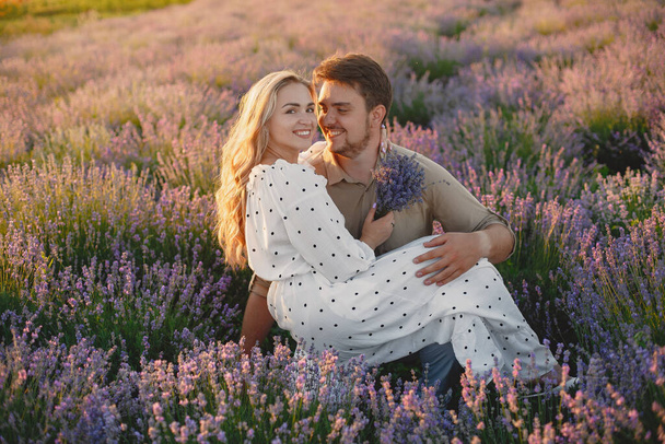 Woman in a white dress with her husband in a lavender field - 写真・画像