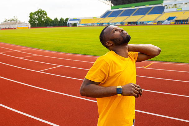 young  fit man stretching on stadium  - Foto, Imagen