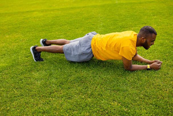 young man exercising on stadium  - Foto, Bild