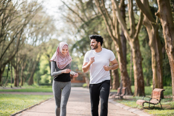 Positive muslim family running together at green park - Photo, Image