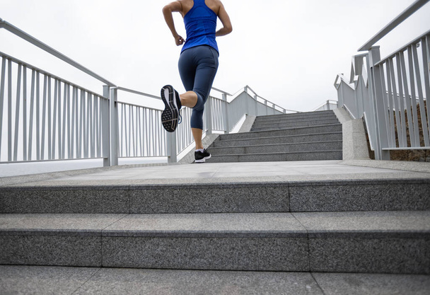 Healthy lifestyle fitness sports woman runner running on seaside trail - Fotó, kép