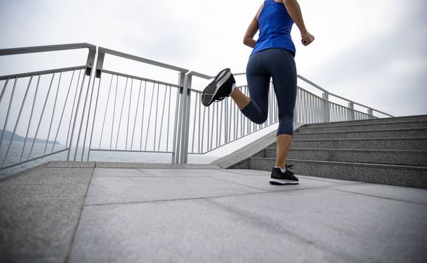 Healthy lifestyle fitness sports woman runner running on seaside trail - Фото, зображення
