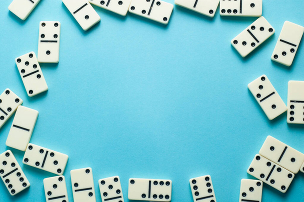 Domino pieces on blue background with an empty space for text - Foto, imagen