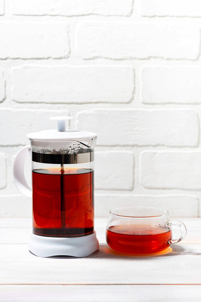 fresh black tea in French press on white background, vertical closeup - Photo, Image