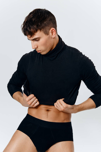 sexy guy in turtleneck sweater and black panties portrait cropped view - Photo, Image