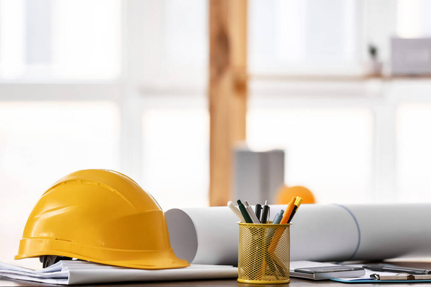 Hardhat of engineer on table in office - Photo, image