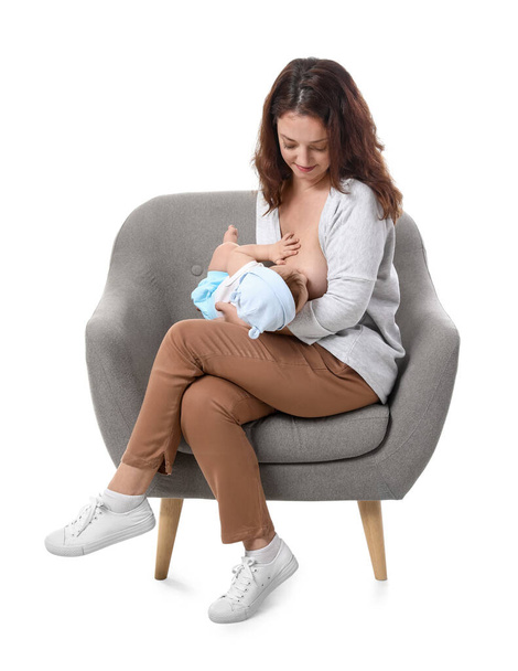 Young woman breastfeeding her baby on white background - Фото, зображення
