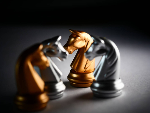 A closeup shot of silver and golden knight chess pieces - Zdjęcie, obraz