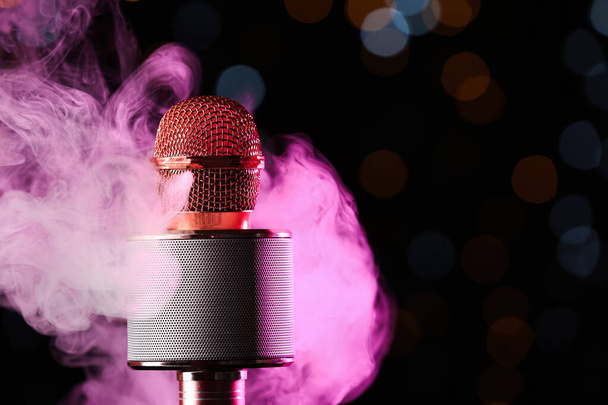 Modern microphone against defocused lights, closeup - Photo, Image