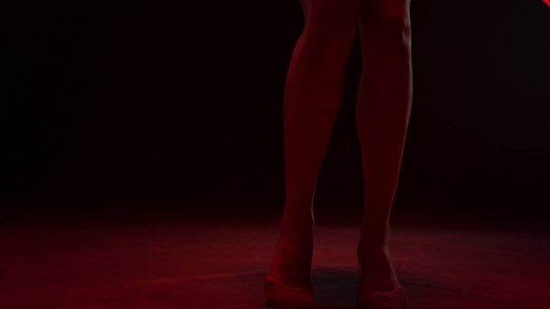 Woman slim legs doing rhythmic gymnastics indoors. Female gymnast performing. - Foto, Bild
