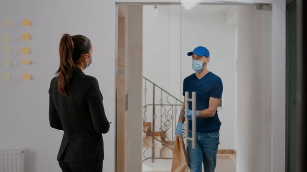 Бизнесмен в маске против коронавируса платит за еду на вынос - Фото, изображение