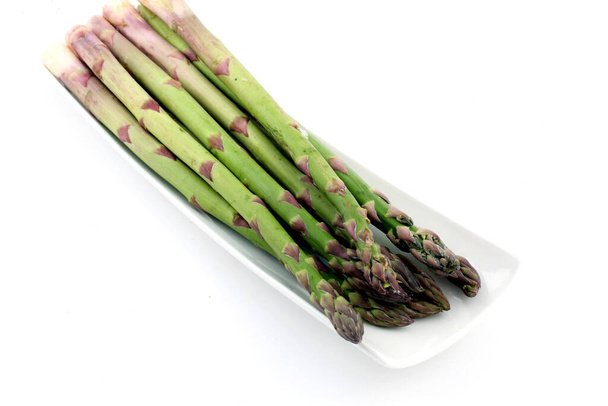 A closeup shot of fresh asparagus isolated on a white background - Fotografie, Obrázek