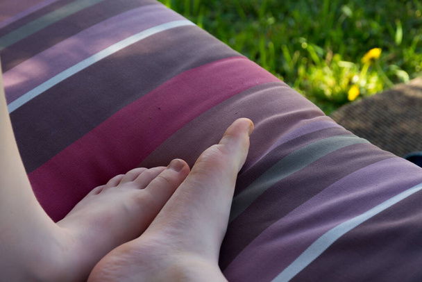 baby feet on the background of the ottoman and grass - Photo, Image